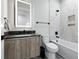 Modern bathroom with a black marble countertop, sleek fixtures, and tub with black trim at 5816 S 3Rd St, Tampa, FL 33611