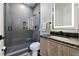 Modern bathroom featuring a glass-enclosed shower, sleek vanity, and contemporary fixtures at 5816 S 3Rd St, Tampa, FL 33611