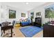 Cozy bedroom with a blue rug, large windows, desk, and ample toy storage at 5816 S 3Rd St, Tampa, FL 33611