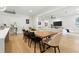 Bright dining area featuring a wooden table with seating for six, seamlessly flowing into the adjacent living room at 5816 S 3Rd St, Tampa, FL 33611