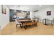 Modern dining area with a wooden table, bench seating, stylish chairs, and sleek kitchen design in the background at 5816 S 3Rd St, Tampa, FL 33611