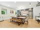 Bright dining area with a wooden table, bench seating, modern lighting, and contemporary kitchen design at 5816 S 3Rd St, Tampa, FL 33611