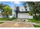 Modern two-story home with a stone accent and large garage, complemented by a lush green lawn and landscaping at 5816 S 3Rd St, Tampa, FL 33611