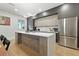 Modern kitchen with stainless steel appliances, white countertops, and a spacious island with seating at 5816 S 3Rd St, Tampa, FL 33611