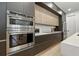 Contemporary kitchen with stainless steel appliances, dark wood cabinets, and sleek white countertops at 5816 S 3Rd St, Tampa, FL 33611