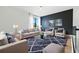 Elegant living room with plush seating, blue accent wall, and geometric-patterned rug at 5816 S 3Rd St, Tampa, FL 33611