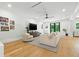 Bright living room with a comfortable sectional sofa, modern furnishings, and views of the outdoor greenery at 5816 S 3Rd St, Tampa, FL 33611