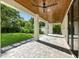 Covered outdoor patio with stone pavers, wooden ceiling, and a view of the expansive green yard at 5816 S 3Rd St, Tampa, FL 33611