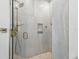 Modern shower featuring marble-style tile, glass door, and gold hardware at 5816 S 3Rd St, Tampa, FL 33611
