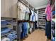 Organized walk-in closet with wooden floors, custom shelving, hanging rods, and ample storage at 5816 S 3Rd St, Tampa, FL 33611