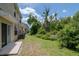 Backyard featuring a grassy area with surrounding greenery and patio space at 6231 Olivedale Dr, Riverview, FL 33578