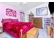Bedroom showcasing pink accent wall with floral decor, and decorative furnishings at 6231 Olivedale Dr, Riverview, FL 33578