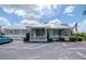 Exterior view of the beautiful community clubhouse with ample parking and manicured landscaping at 6231 Olivedale Dr, Riverview, FL 33578