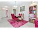 Open dining area featuring wood table, red chairs, decorative rug, and stylish decor at 6231 Olivedale Dr, Riverview, FL 33578
