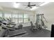 A well-equipped fitness center with treadmills, an elliptical machine, and weight machines by large windows at 6231 Olivedale Dr, Riverview, FL 33578