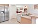Well-lit kitchen featuring stainless steel refrigerator and adjacent dining space at 6231 Olivedale Dr, Riverview, FL 33578