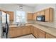 Bright kitchen features ample cabinetry, a stainless-steel refrigerator, and a double sink below a window at 6231 Olivedale Dr, Riverview, FL 33578