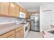 Bright kitchen with stainless steel refrigerator, white oven, and ample cabinet space at 6231 Olivedale Dr, Riverview, FL 33578