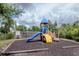 Neighborhood playground with slide and climbing area nestled in a secure wood-chip-covered area at 6231 Olivedale Dr, Riverview, FL 33578