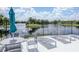 Community pool featuring comfortable lounge chairs, tables, and umbrellas, with tranquil views of the pond at 6231 Olivedale Dr, Riverview, FL 33578