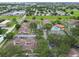 This aerial shows the community with a pool, tennis courts, parking, and lush surroundings at 6262 142Nd N Ave # 1302, Clearwater, FL 33760