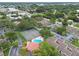 Community aerial view featuring well-maintained tennis courts, a sparkling pool, and lush landscaping in a residential neighborhood at 6262 142Nd N Ave # 1302, Clearwater, FL 33760