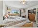Bedroom features a comfy bed, ample natural light, and a spacious closet for storage at 6262 142Nd N Ave # 1302, Clearwater, FL 33760