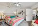 Bright bedroom featuring a comfy bed, ceiling fan, and carpeted floor, along with decor and open doorway at 6262 142Nd N Ave # 1302, Clearwater, FL 33760