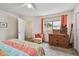 Comfortable bedroom featuring soft carpet, ceiling fan, natural light, and closet for ample storage at 6262 142Nd N Ave # 1302, Clearwater, FL 33760
