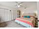 Spacious bedroom with a ceiling fan, ample closet space, and soft carpet flooring, creating a comfortable retreat at 6262 142Nd N Ave # 1302, Clearwater, FL 33760
