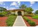 Clubhouse at Via Verde with paved walkway, manicured landscaping, and inviting entrance at 6262 142Nd N Ave # 1302, Clearwater, FL 33760