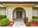 Welcoming clubhouse entrance framed by lush greenery and decorative landscaping at 6262 142Nd N Ave # 1302, Clearwater, FL 33760