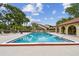 Community pool with clean, inviting water and ample seating areas with umbrellas at 6262 142Nd N Ave # 1302, Clearwater, FL 33760