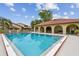 Community pool with a view of nearby condos, surrounded by ample deck space at 6262 142Nd N Ave # 1302, Clearwater, FL 33760