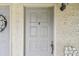 Close up of the unit front door with a decorative wreath and a small welcome sign at 6262 142Nd N Ave # 1302, Clearwater, FL 33760