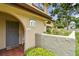 Inviting condo entrance with gray door, decorative accents, and well-maintained landscaping at 6262 142Nd N Ave # 1302, Clearwater, FL 33760