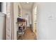 Bright hallway featuring carpet flooring, a decorative shelf, and access to other rooms and the bathroom at 6262 142Nd N Ave # 1302, Clearwater, FL 33760