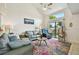 Bright living room boasts a colorful rug, comfortable seating, and a sliding glass door to the outdoors at 6262 142Nd N Ave # 1302, Clearwater, FL 33760