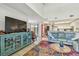 Open-concept living area featuring a comfortable blue sofa, colorful rug and view to outdoor seating area at 6262 142Nd N Ave # 1302, Clearwater, FL 33760