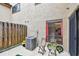 Cozy patio area with a window view to a kitchen and seating, plus an air conditioner and partial fence at 6262 142Nd N Ave # 1302, Clearwater, FL 33760