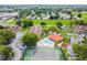 Aerial view of a community pool, tennis court, and lush greenery in a well-maintained residential complex at 6262 142Nd N Ave # 1302, Clearwater, FL 33760
