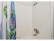 Tiled shower and tub combination with a colorful shower curtain, adding a modern and functional bathroom feature at 6262 142Nd N Ave # 1302, Clearwater, FL 33760
