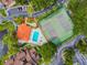 Aerial view of community pool, tennis court and landscaping at 6262 142Nd N Ave # 1302, Clearwater, FL 33760