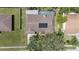 Aerial view of home featuring solar panels, a fenced yard, swimming pool, landscaping and a mature shade tree at 6706 Dunes Ln, Temple Terrace, FL 33617