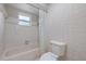 Bathroom featuring a tub and shower combination with tile surround at 6706 Dunes Ln, Temple Terrace, FL 33617
