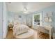 Bedroom with a window, fan, and stylish décor at 6706 Dunes Ln, Temple Terrace, FL 33617