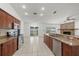 Modern kitchen featuring stainless steel appliances, a breakfast bar, and open layout to the dining area at 6706 Dunes Ln, Temple Terrace, FL 33617