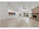 Bright living room with tile flooring, fireplace, and sliding doors that lead to outdoor living at 6706 Dunes Ln, Temple Terrace, FL 33617