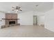 Bright living room featuring a brick fireplace and light tile flooring at 6706 Dunes Ln, Temple Terrace, FL 33617