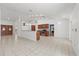 Open concept living area with tile flooring, a breakfast bar, and seamless flow between kitchen and dining at 6706 Dunes Ln, Temple Terrace, FL 33617